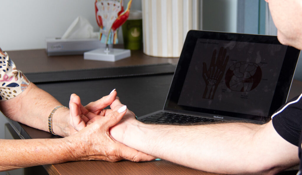 Woman Touching Man's Wrist with Laptop That Has Hand Parts
